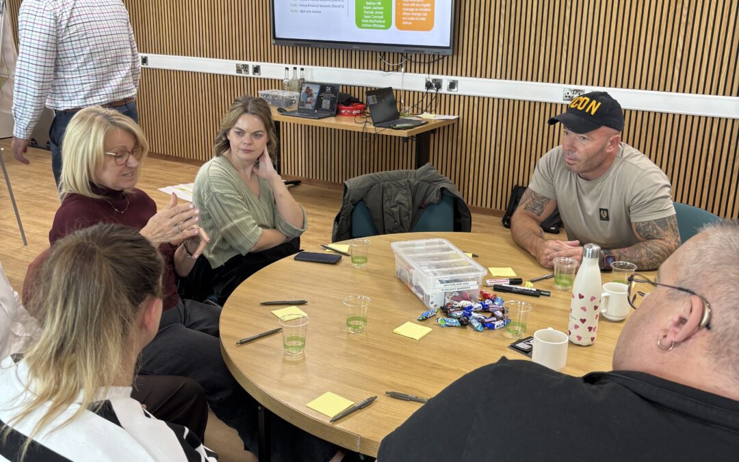 Steven Kirby seated at a table in conversation with attendees at the Biotech4 event